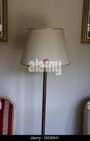 Warning sign on lampshade, not to hang anything on it Stock Photo
