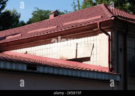 Modern roof made of metal. Corrugated metal roof and metal roofing. Stock Photo