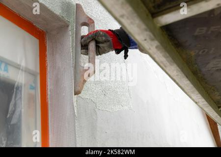 Close-up of a worker's hand doing the finishing touches. Stock Photo