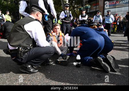 London, UK. 06/10/2022,  Just Stop Oil activists protested in Trafalgar Square and some glued their hands to the road. The protest has been part of a series of demonstrations taking place in Westminster by the Climate Action Environmental Group. Stock Photo