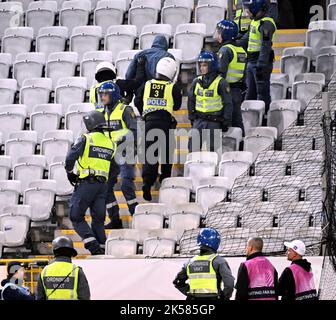 Malmö, Sweden, 6 October 2022. Riot police arrest and take away a person after supporters set off fireworks on both the pitch and the stands during Thursday's Europa League, Group D football match between Malmö FF and FC Union Berlin at Eleda Stadium, Malmo, Sweden, 6 October 2022 Photo: Johan Nilsson / TT / 50090 Stock Photo