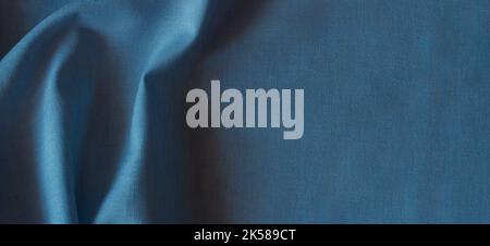 Abstract crumpled linen fabric texture background. Natural blue color dyed linen organic eco textiles canvas background. Top view Stock Photo