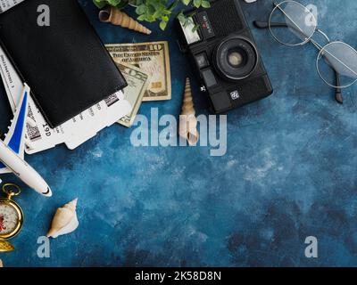Travel planning, air flight. On a dark blue background, documents, money, a camera, a small plane. Pleasant adventure, vacation, tourism, business tri Stock Photo