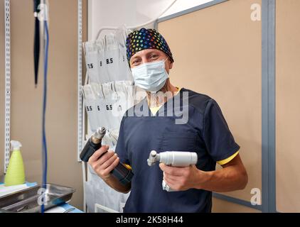Veterinarian performing knee surgery on small dog in clinic Stock Photo