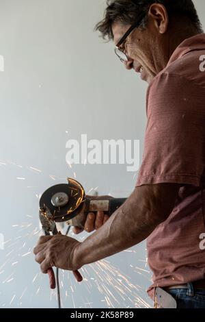 latino man looking for tools in his toolbox, hispanic, with screwdriver in hand Stock Photo