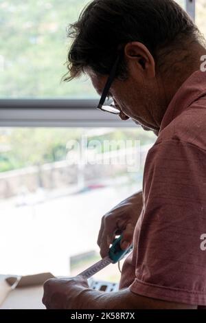 Handyman using screwdriver to fix tv, repair and installation services Stock Photo