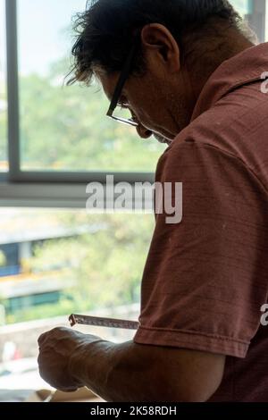 Handyman using screwdriver to fix tv, repair and installation services Stock Photo