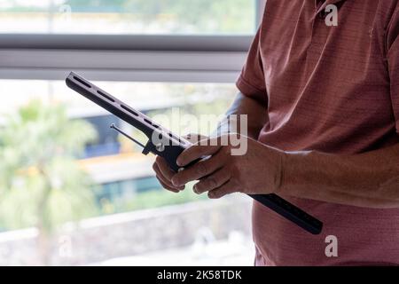 latino man looking for tools in his toolbox, hispanic, with screwdriver in hand Stock Photo
