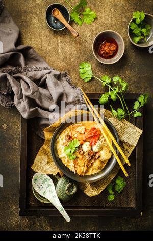Curry Laksa. Peranakan noodle soup with seafood in spicy coconut milk soup from Singapore Stock Photo