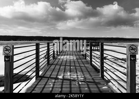 Afternoon winter photo of the Myers Point pier at Myers Town Park in Lansing NY, Tompkins County. The dock is situated on the shore of Cayuga Lake, ne Stock Photo