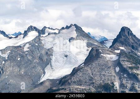 Rugged peaks and glaciers across Garibaldi Lake from Panorama Ridge. Stock Photo