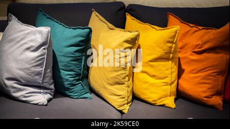 Sofa with colorful pillows in room. Home interior with Colorful pillows on a sofa. Nobody, selective focus. Stock Photo