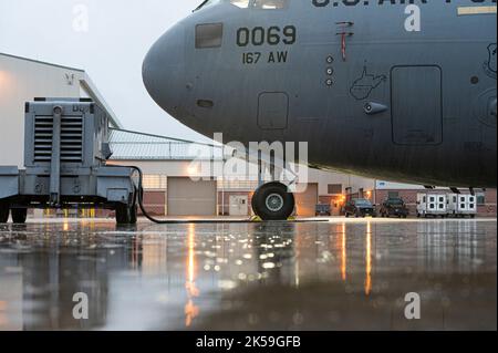 Light reflects off rain on the tarmac early in the morning at the 167th Airlift Wing, Martinsburg, West Virginia, Oct. 2, 2022. Remnants of Hurricane Ian passed through the area creating long periods of showers during the wing’s October unit training assembly. (U.S. Air National Guard photo by Senior Master Sgt. Emily Beightol-Deyerle) Stock Photo