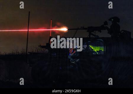 A United Kingdom Royal Marine from 45 Commando fires an M2 .50 caliber machine gun during a live-fire exercise at Grafenwöhr Training Area, Germany, Sept. 22, 2022. This Special Forces-led exercise is designed to improve their ability to work with the United Kingdom’s commando forces in a time of crisis. (U.S. Navy photo by LT Rob Kunzig) Stock Photo