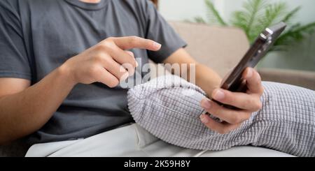 Close up of man hands using mobile smartphone at home, Searching or social networks concept. Stock Photo