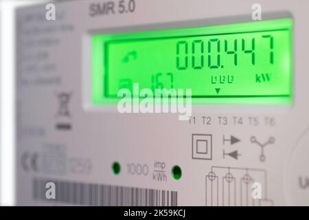 Modern smart electricity meter with green display in a Dutch household. Narrow depth of field Stock Photo