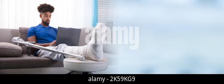 Injured Man Broken Leg Cast. African American Home Accident Stock Photo