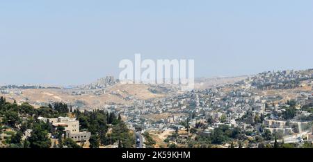 A view of the South Eastern arab neighborhoods along the security barrier in Jerusalem. Stock Photo