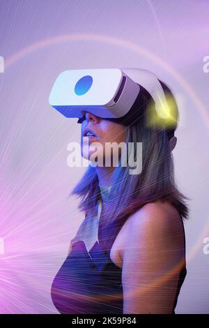Woman is using virtual reality headset. Concept of virtual, augmented and extended reality, metaverse, entertainment and communication. Stock Photo