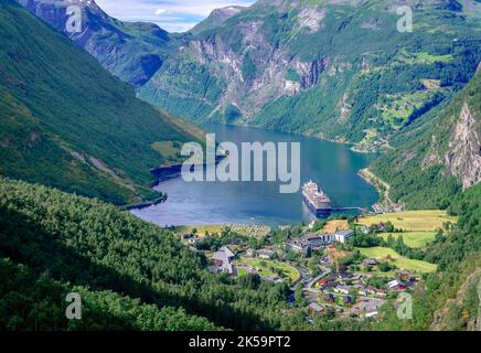 Panoramic view of Geiranger, a small tourist village at the head of the Geirangerfjord.  Photo taken from Flydalsjuvet viewpoint. Stock Photo