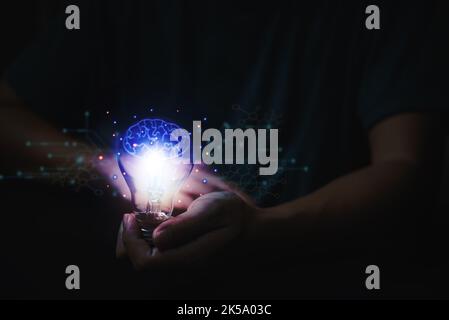 Innovation technology and creativity concept. Hands holding light bulb future icon brain and network connection on virtual interface in science and co Stock Photo