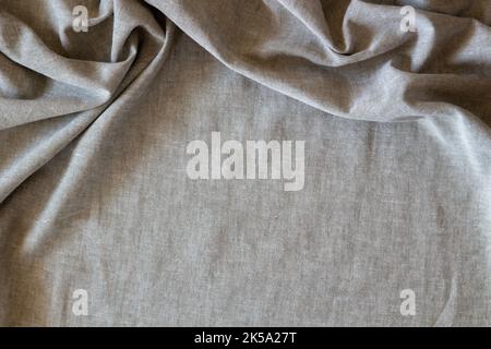 Abstract crumpled linen fabric texture background. Natural solid linen organic eco textiles canvas background. Top view Stock Photo