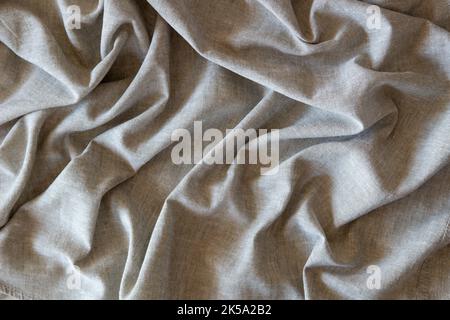 Abstract crumpled linen fabric texture background. Natural solid linen organic eco textiles canvas background. Top view Stock Photo