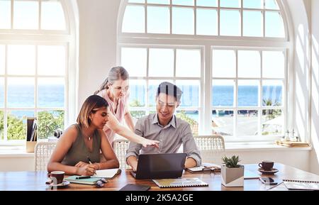 Teamwork, diversity and laptop for collaboration working on strategy, planning and digital marketing ideas sitting at table. Man and women team in Stock Photo