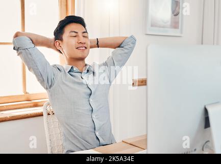 Relax, calm and peace at work of a business man from China taking a break in a office. Businessman and asian IT tech employee feeling proud and happy Stock Photo