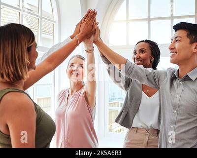 Group, high five and collaboration success on business project in office conference room. Teamwork, celebration and happy employees with diversity Stock Photo