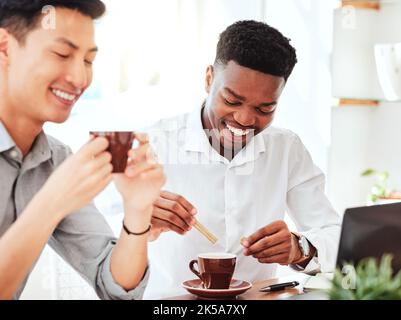 Business meeting, working and men with coffee and laptop in cafe. Diversity, black man and Asian man in coffee shop, smiling and drinking tea on Stock Photo
