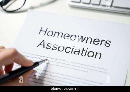 Person Reading HOA Rules And Regulations Document Stock Photo