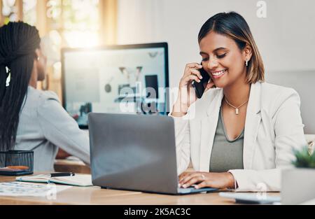 Phone, laptop and communication with a woman graphic designer talking on a call in her office. Computer, creative and design with a female employee Stock Photo