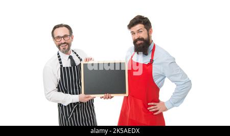 Hiring staff. Men bearded hipster informing you. Men bearded bartender or cook in apron hold blank chalkboard. Bartender with blackboard. Hipster Stock Photo