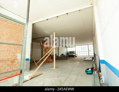 Refurbishment of a large industrial building. The construction site in the phase of remaking of the systems and walls in masonry and plasterboard. Stock Photo