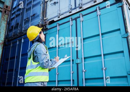 Checklist, cargo and container management by woman, working with delivery and logistics. Shipping, stock and supply chain inspection by lady writing Stock Photo