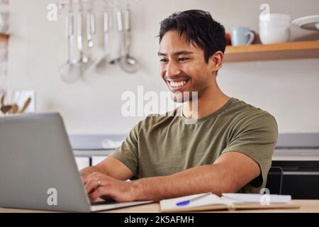 Internet, technology and man kitchen with laptop, happy freelance worker from India. Startup work from home, Indian businessman with smile doing Stock Photo