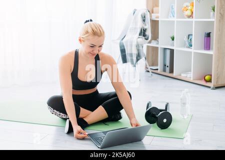 online sport athletic woman home gym healthy Stock Photo