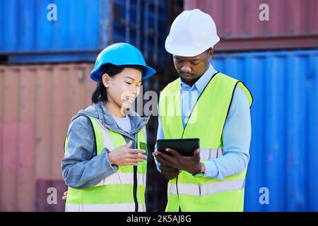 Logistics, tablet and employees planning delivery of shipping container on technology while working together at a port. Outdoor warehouse workers Stock Photo