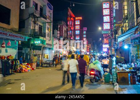 NEW DELHI - SEP 19: Old Indian street market The Main Bazar with traditional glowing signs in New Delhi on September 19. 2022 in India Stock Photo