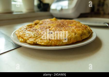 Traditional Spanish tortilla on a plate, prepared at home Stock Photo