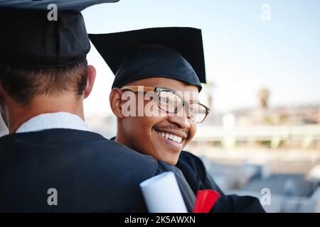 Happy, graduation and college graduate hug with happiness and congratulations outdoor smile. University, college success and diploma event of a black Stock Photo