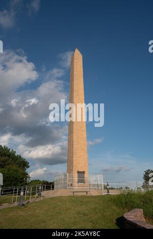 A vertical shot of Sergeant Floyd Monument on blue cloudy sky background in Sioux City, Iowa Stock Photo