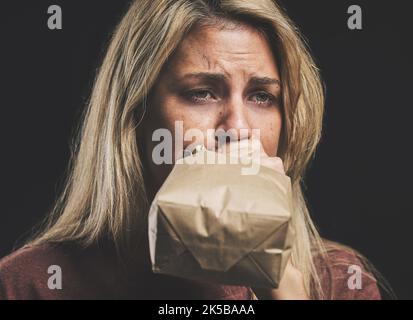 Anxiety, nausea and woman with paper bag for stress and panic attack relief with black mockup. Girl suffering with trauma, psychosis and mental health Stock Photo