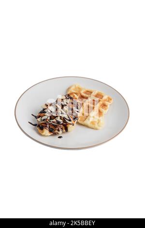 Croffles with almonds chocolate sauce topping and caramel on plate on white background isolated clipping path Stock Photo