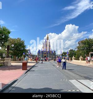 Orlando, FL USA - July 25, 2020 : People walking toward Cinderella Castle at Walt Disney World Magic Kingdom in Orlando, Florida. Stock Photo