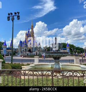 Orlando, FL USA - July 25, 2020 : People walking toward Cinderella Castle at Walt Disney World Magic Kingdom in Orlando, Florida. Stock Photo