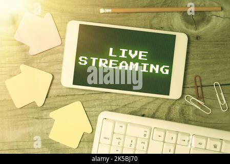 Writing displaying text Live Streaming. Concept meaning displaying audio or media content through digital devices Stock Photo