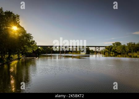 The old railroad trestle in Manitowoc, Wisconsin, formally known as the Manitowoc High Trestle, crosses the Manitowoc River and was built in 1906. Stock Photo