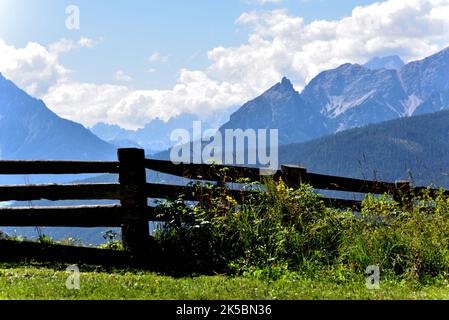 From the Tesido wood view of Mount Pollice, Daumkofel, of 2259 meters with the Dolomite group of Cristallo covered by clouds in the background Stock Photo